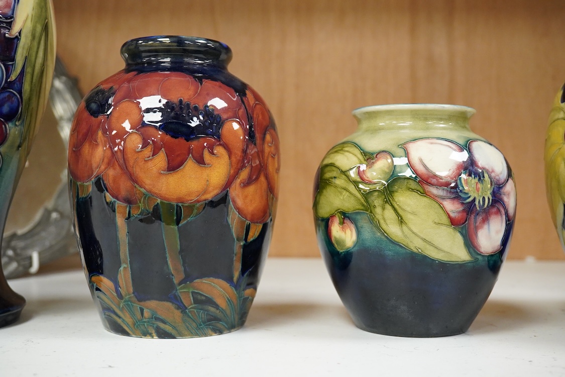 Three Moorcroft vases and a Moorcroft Hibiscus jar and cover, largest 25cm high